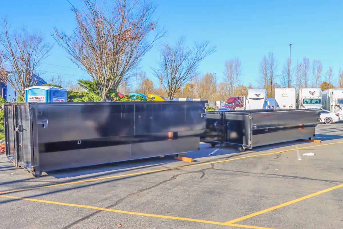 Professional dumpster rental service with roll-off container on residential driveway in Jenks